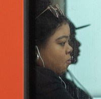 woman wearing wireless anc earbuds on train