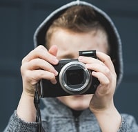 kid holding the camera