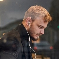 man using noise canceling earbuds