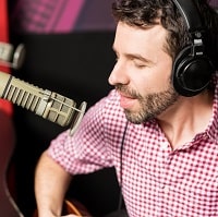 man singing with headphones on