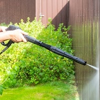 pressure washer cleaning the fences