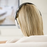 woman watching tv with headphones