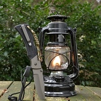 Kerosene lamp, knife and fire striker waiting for survival adventure.